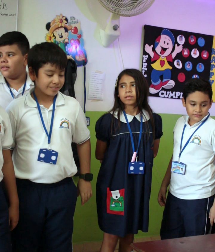 Estudiantes de primaria sonriendo en su salón